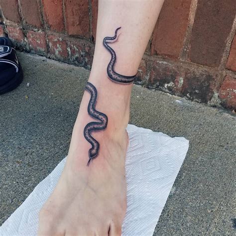 Snake tattoos around leg